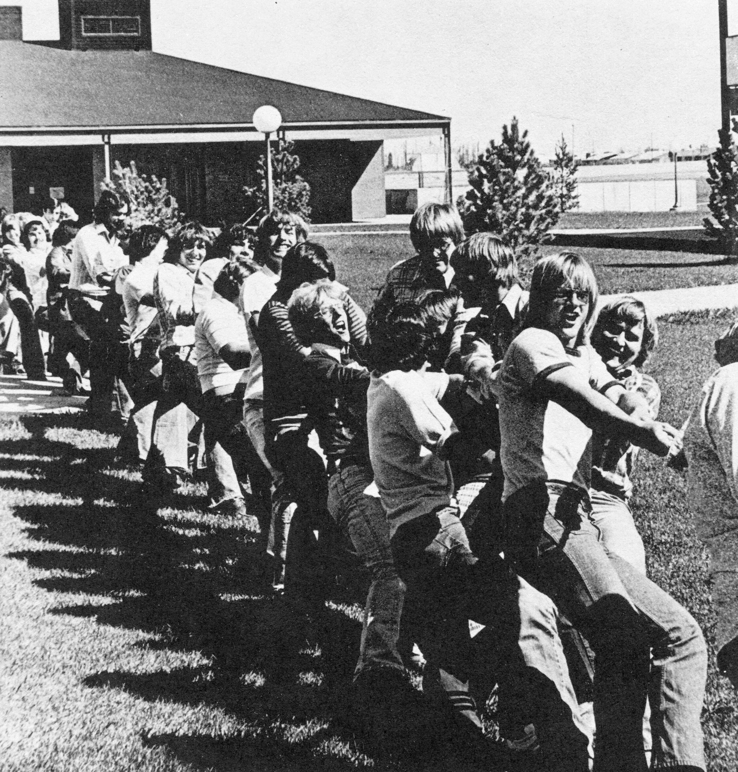 Students compete in a tug-of-war contest south of the Physical Education building during Spring Fling 1976. [College Archives]