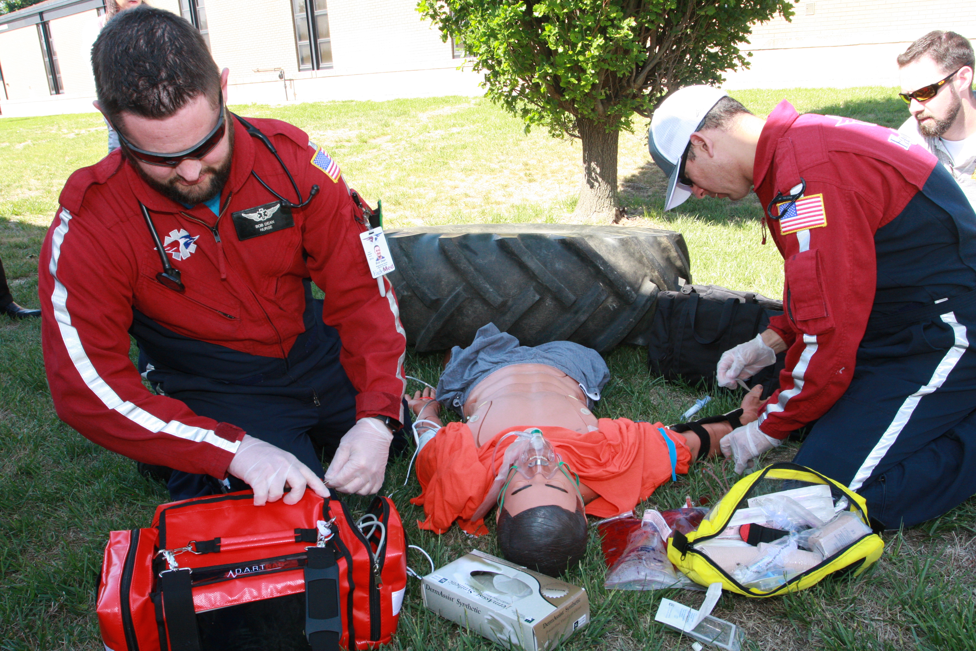 EagleMed personnel stabilize pinned advanced medical simulation mannequin during training scenario