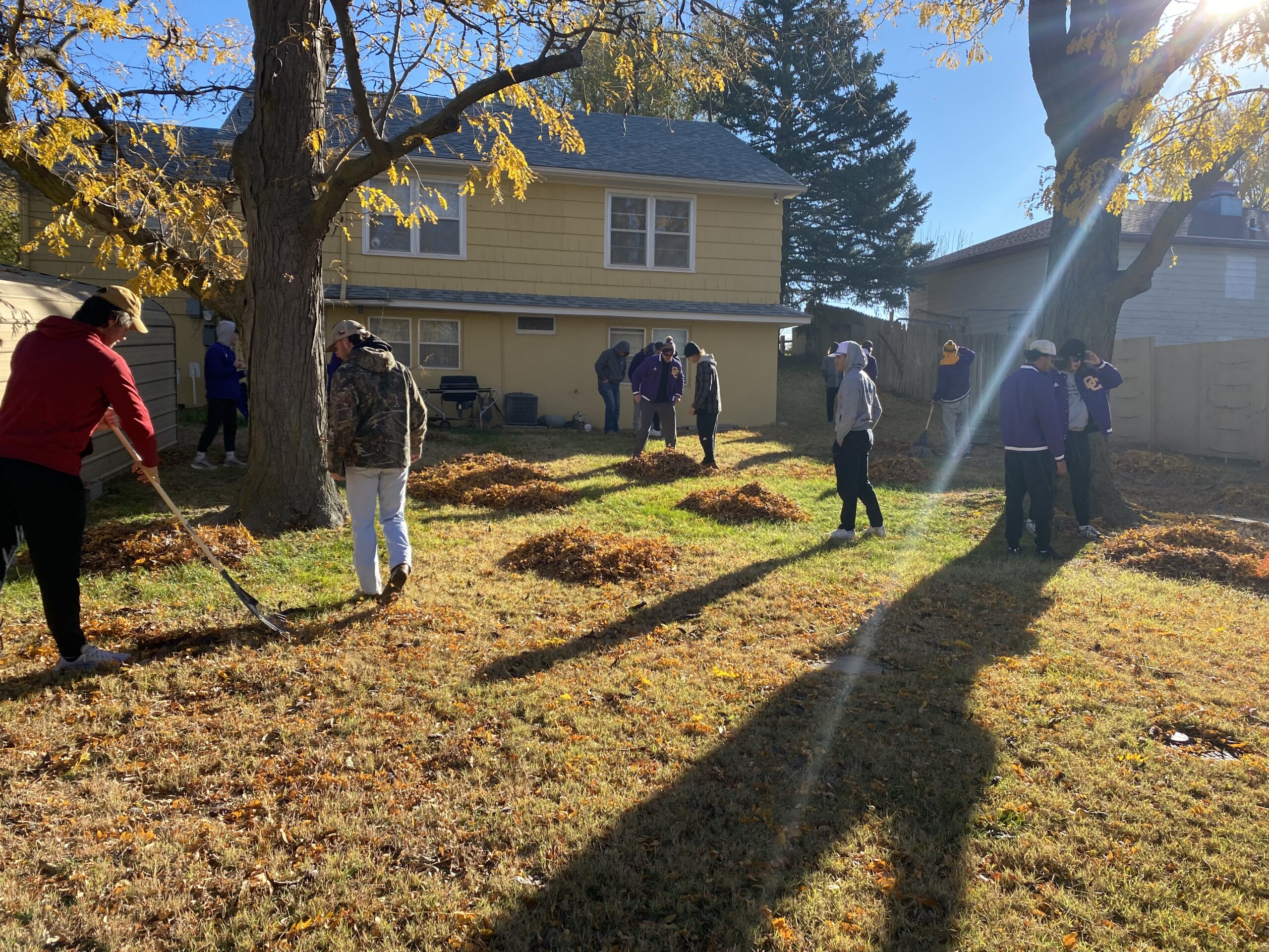 Members of the DC3 baseball team rake leaves during the annual Fall Cleanup Day for Dodge City area senior citizens on Sunday, Nov. 14. [Photo by Annalynn Kirkhart]