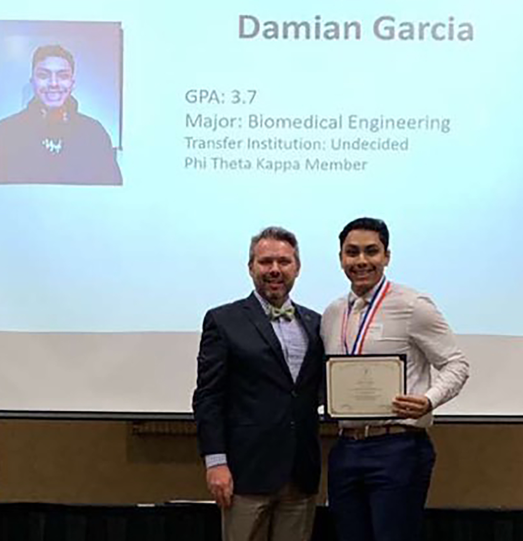DC3 student, Damian Garcia (right), was named to the All-Kansas Academic Team on April 1. Also pictured is DC3 Associate Professor of Vocal Music and PTK Advisor, Kerry J. Kuplic. [Photo courtesy of Cesar Garcia]
