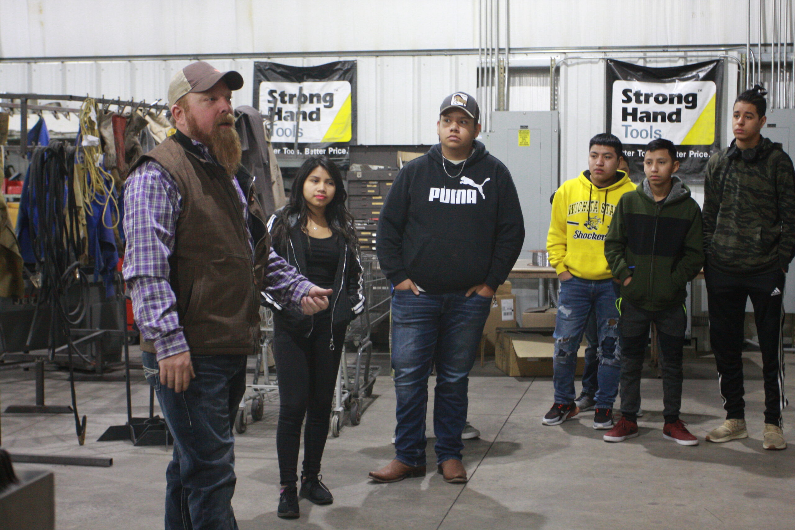 Students from Dodge City High School listening to Justin Weil, associate professor of welding on ag & diesel day