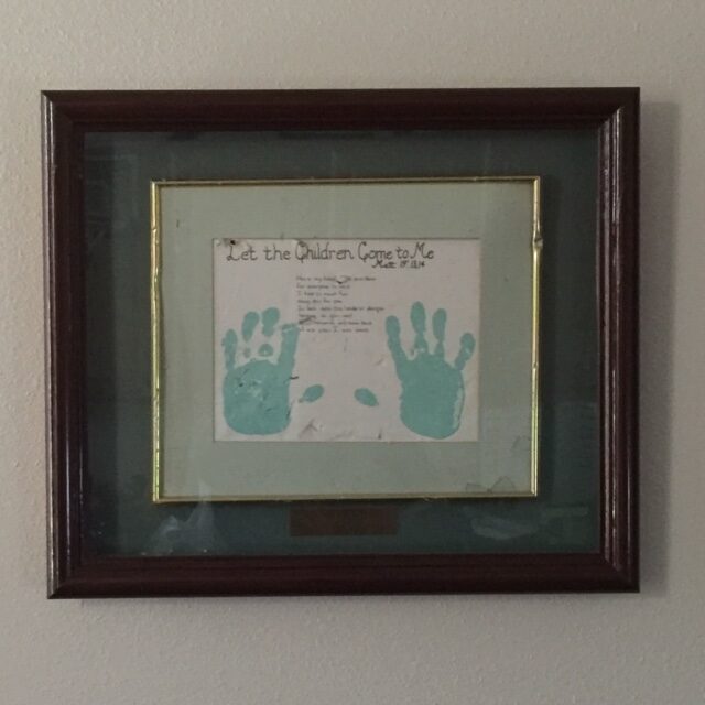 Picture of Dr. Forgey son's handprints hanging on his wall.