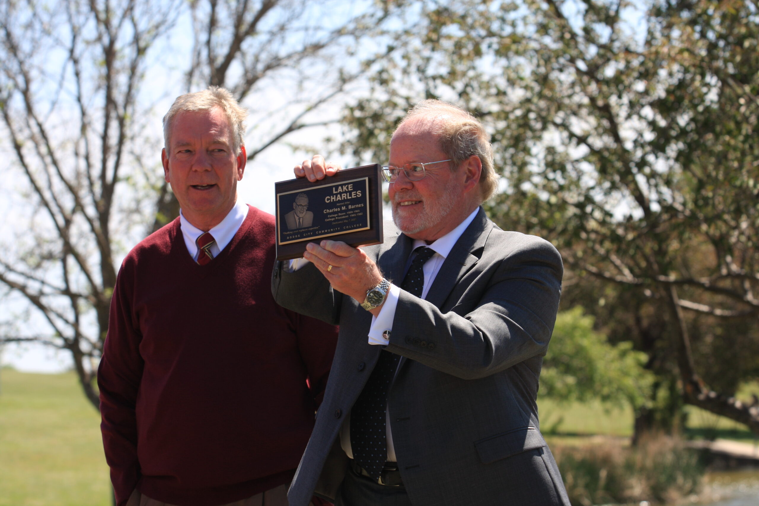 Dr. Harold Nolte, DC3 President (left), presents Dr. Roger Barnes with a replica of the bronze plaque unveiled at the Lake Charles dedication on May 7. [Photo by Justin Wilson]