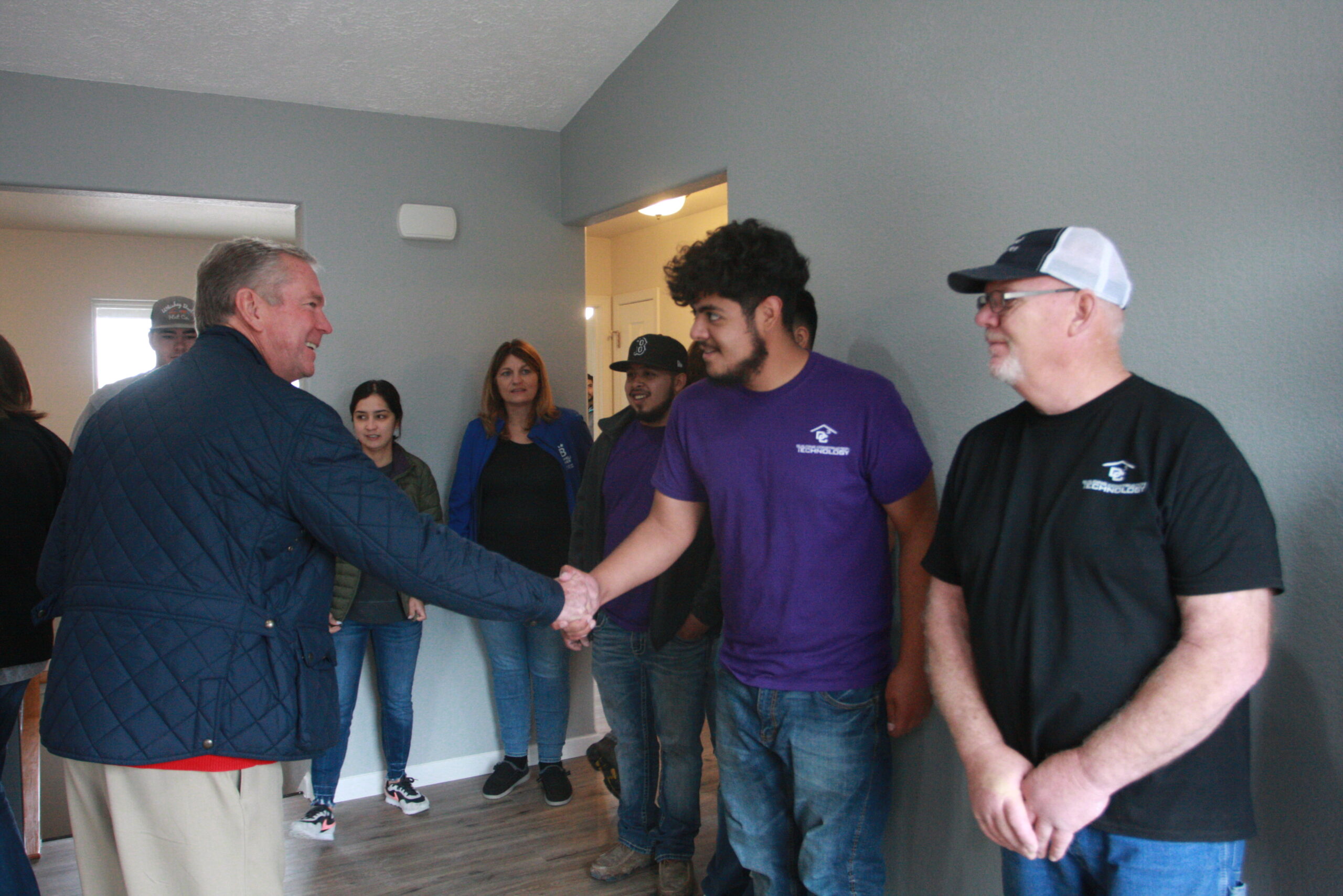 Dr. Harold Nolte, DC3 President shakes hands with BCT Students
