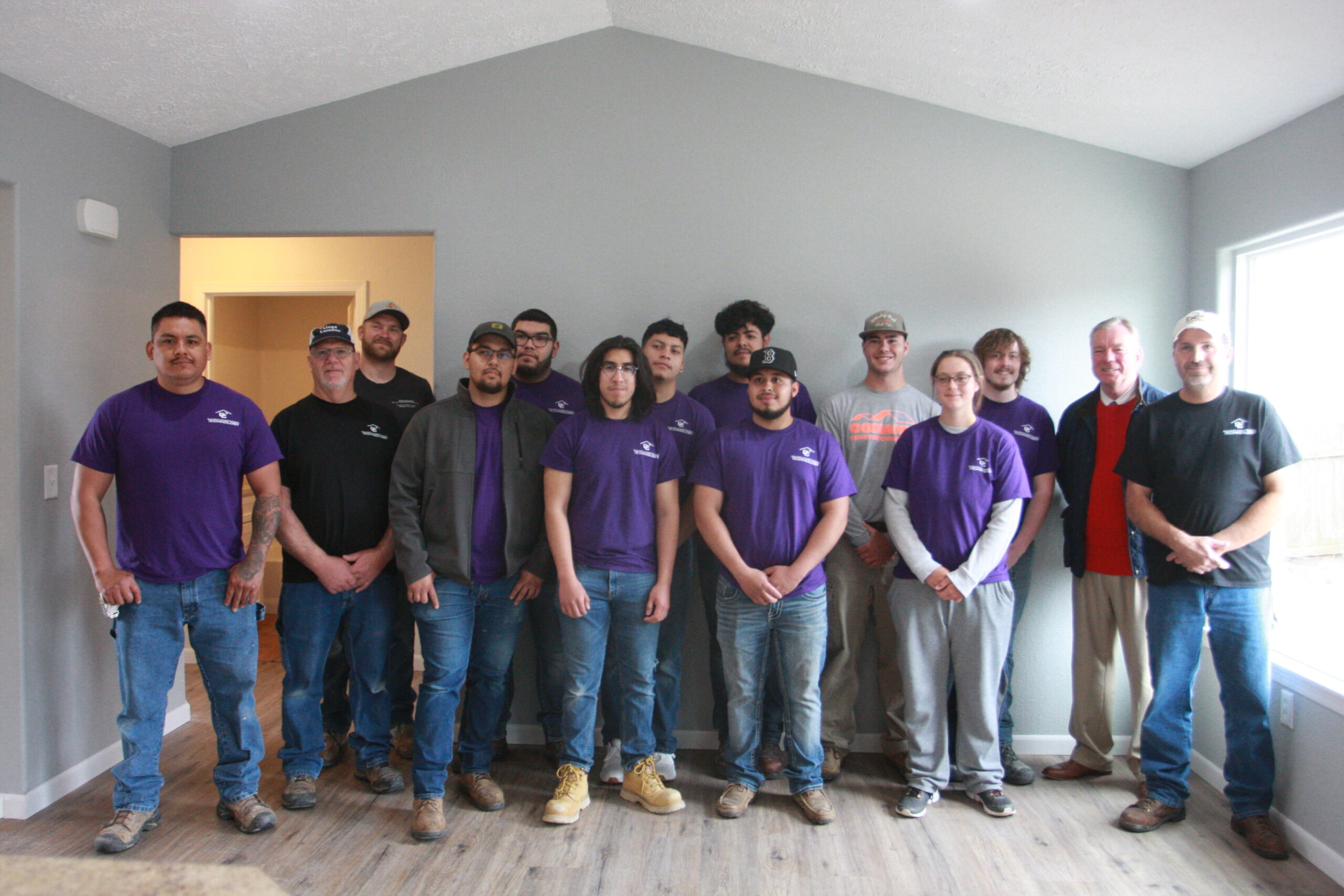 DC3 students and staff gather for a photo during Tuesday’s open house at 1601 Mulberry Circle. Through this ongoing partnership with the Community Housing Association of Dodge City (CHAD), DC3 Building Construction Technology students learn all facets of the building process